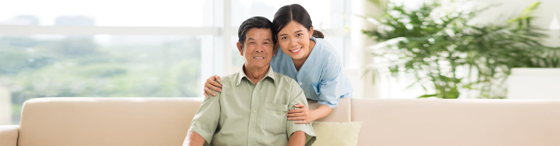 young caregiver and old man smiling